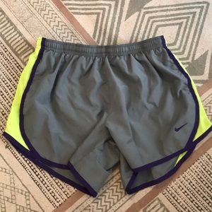Gray, neon yellow, and purple Nike running shorts